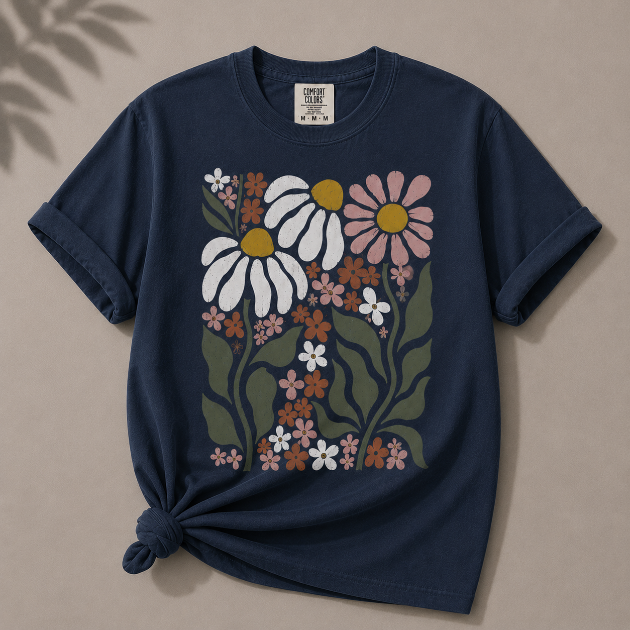 Navy blue t-shirt with floral design on a beige background