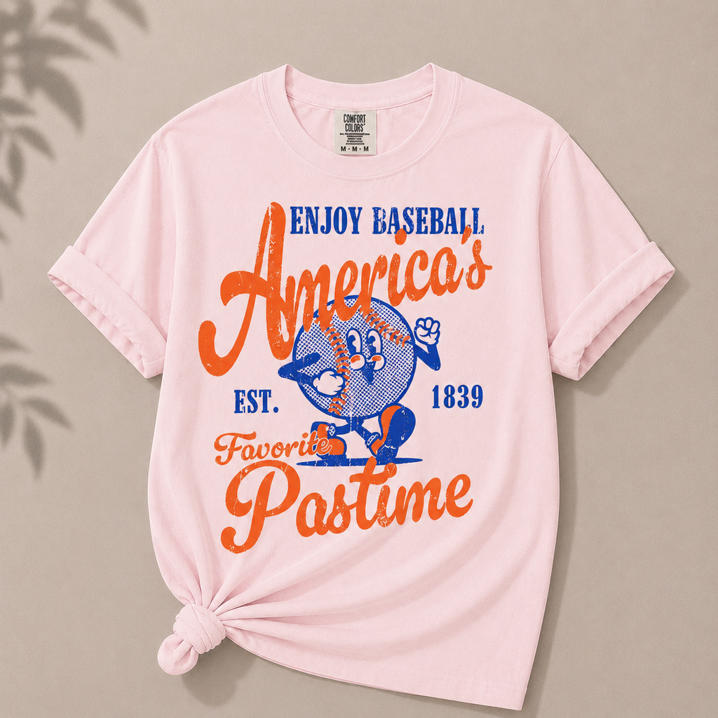 Pink t-shirt with baseball-themed graphic and text on a beige background