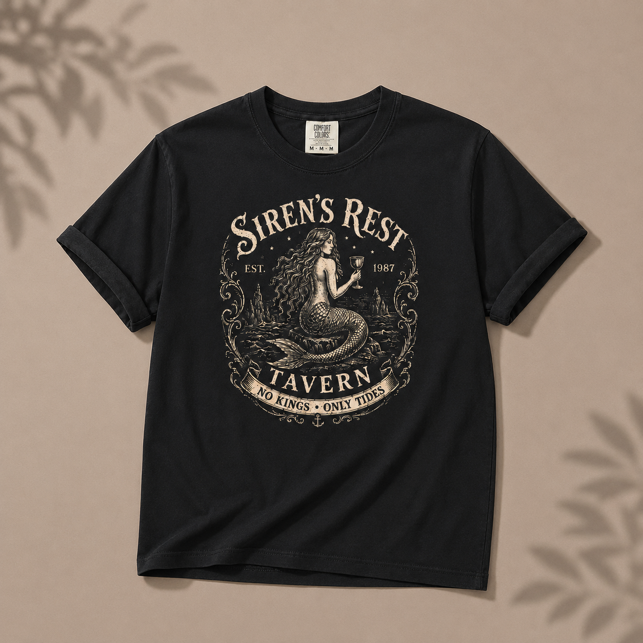 Black t-shirt with 'Siren's Rest Tavern' graphic on a beige background