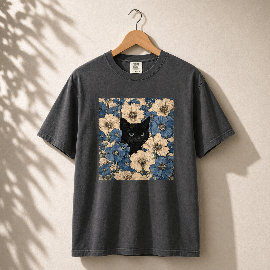 Black t-shirt with a floral pattern and black cat design on a beige background