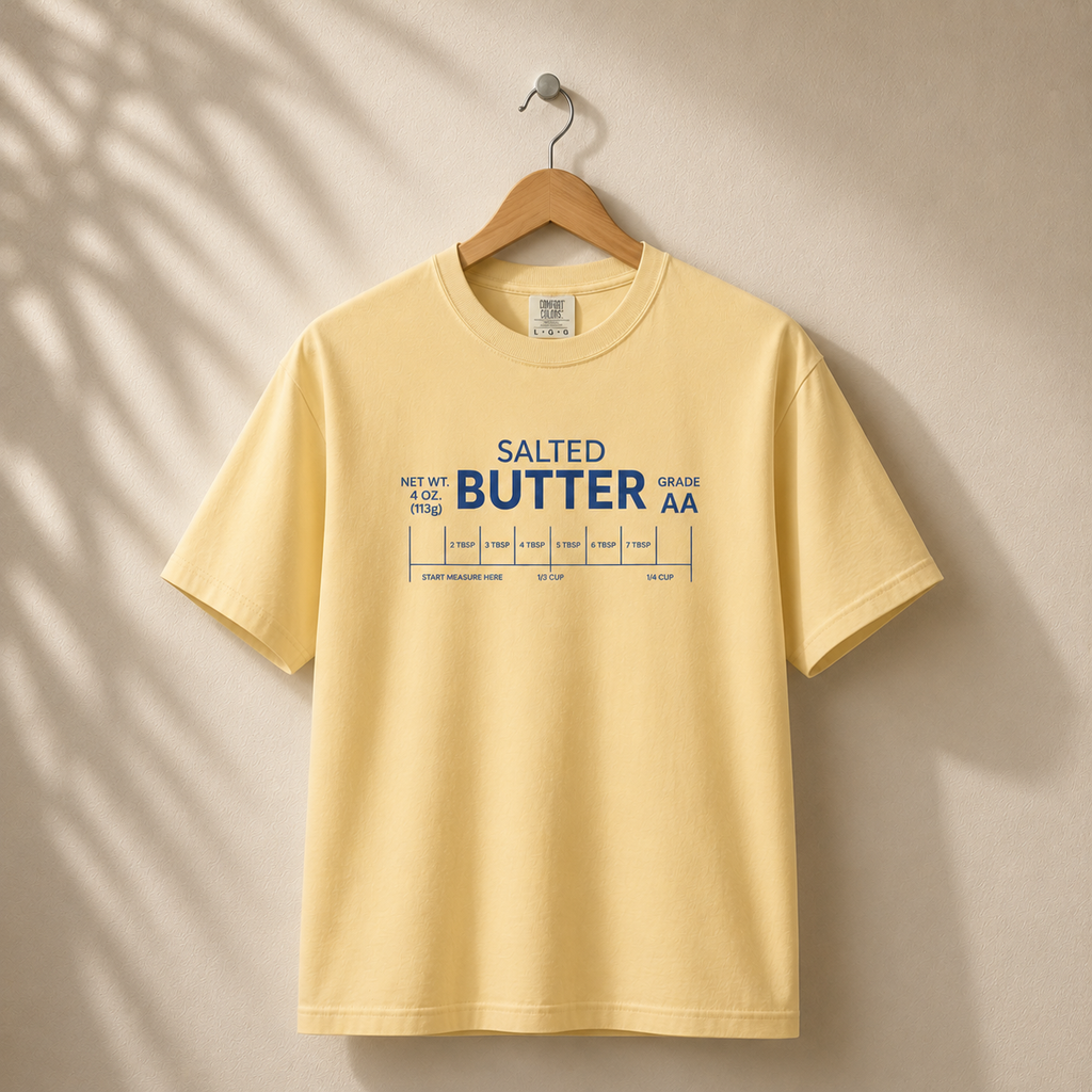 Yellow t-shirt with 'Salted Butter' text on a beige background