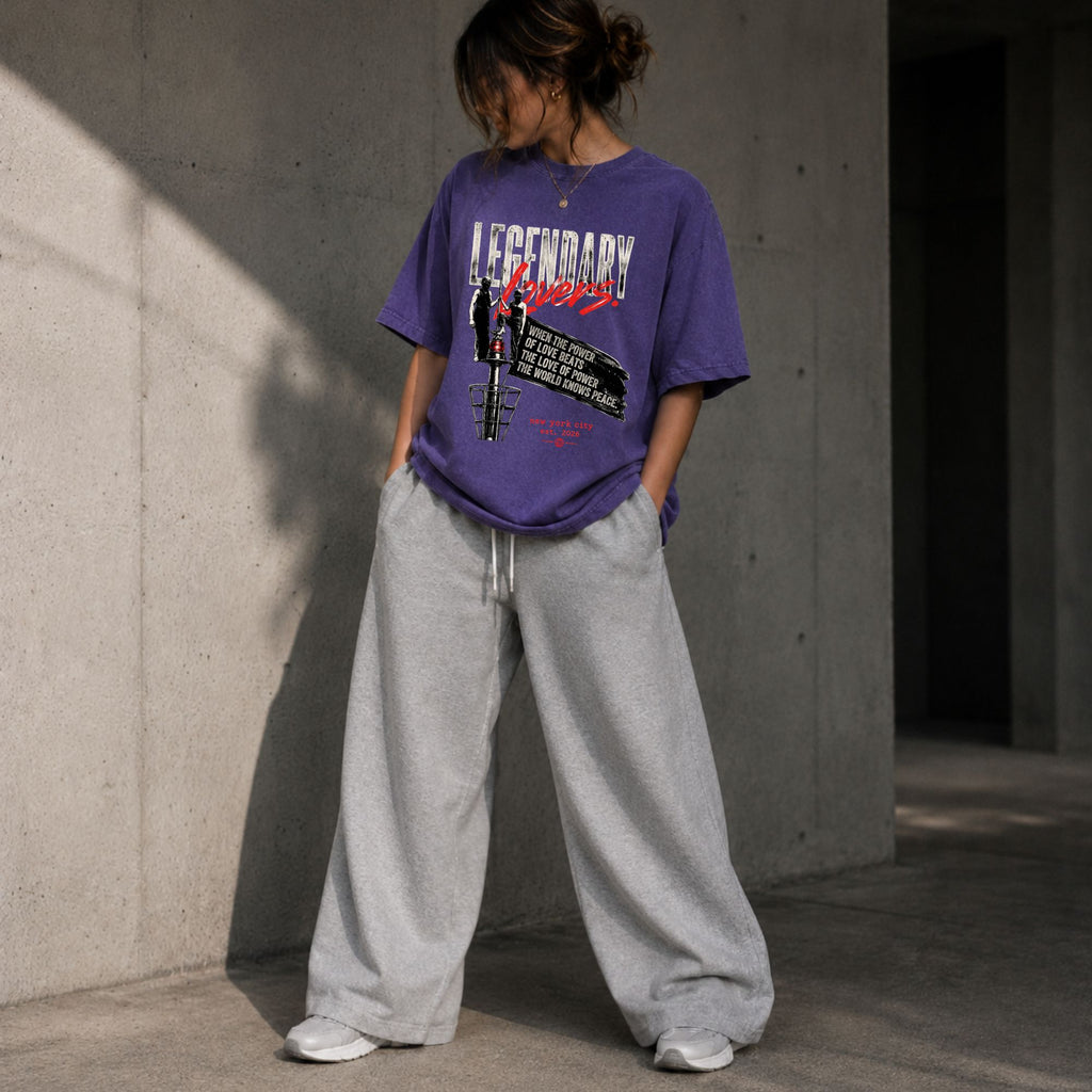 Woman wearing the Purple Haze vintage washed oversized Legendary Lovers graphic T-shirt with a relaxed streetwear fit. Premium heavyweight tee featuring distressed artwork and grunge aesthetic from Form Else Store.