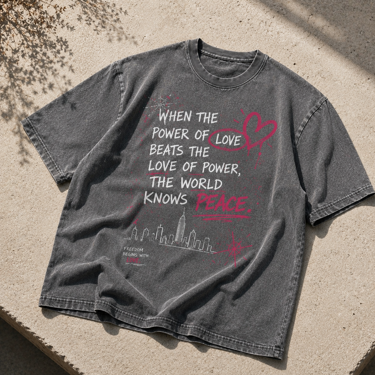 Pirate gray snow washed oversized graphic t-shirt featuring the "When the Power of Love Beats the Love of Power" design, premium heavyweight cotton unisex streetwear tee with a faded wash finish.