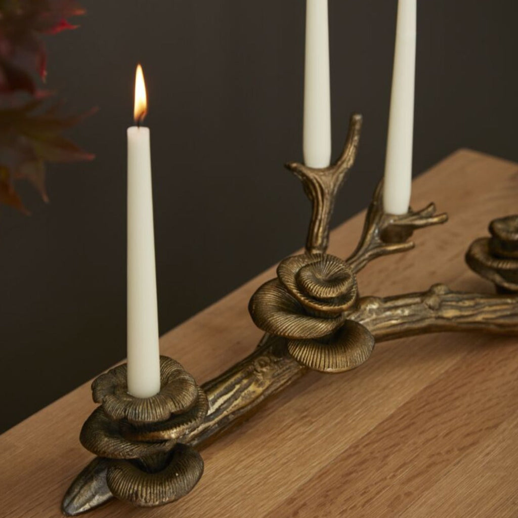 Close-up detail of antique gold oyster mushroom candle cups