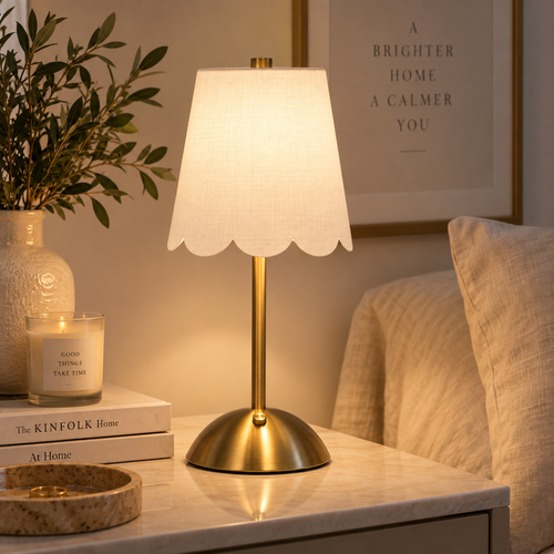 Cordless brass scalloped table lamp in a warm neutral interior