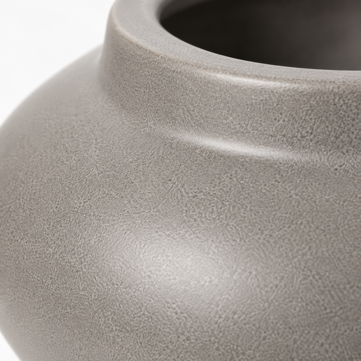 Close-up of matte gray ceramic vase texture and rim