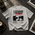 Legendary Lovers oversized graphic tee laid flat on a dark textured surface with natural light.