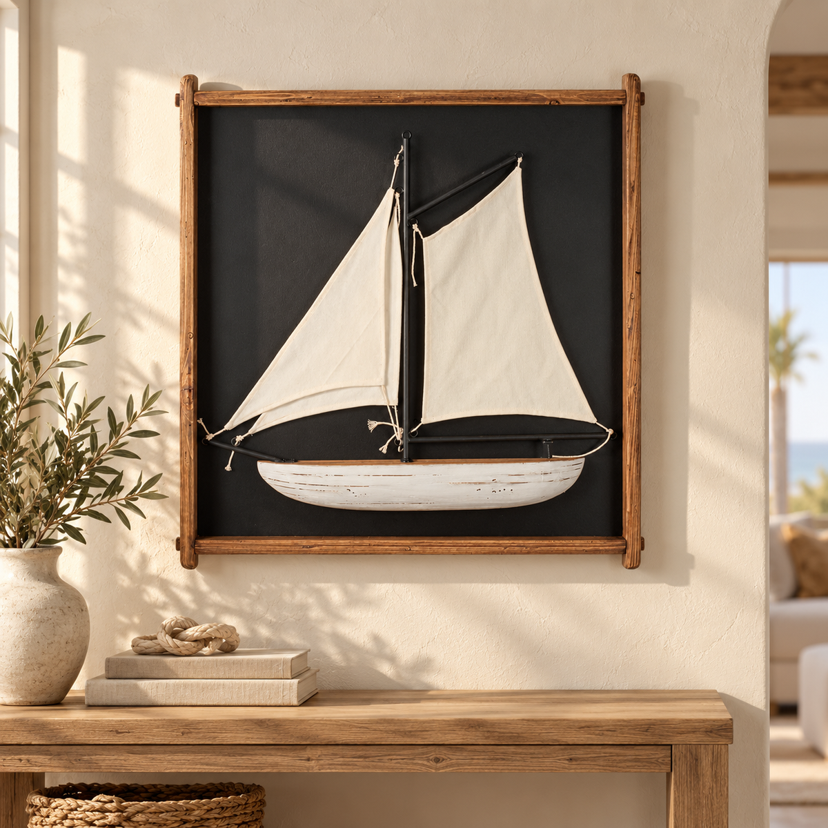 Framed sailboat wall art above a light oak console in a coastal living room