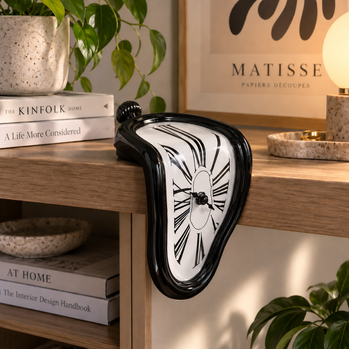 Black melting clock styled on a modern wooden shelf