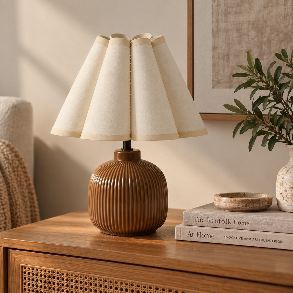 Brown ceramic accent lamp styled on a wood console in a neutral interior