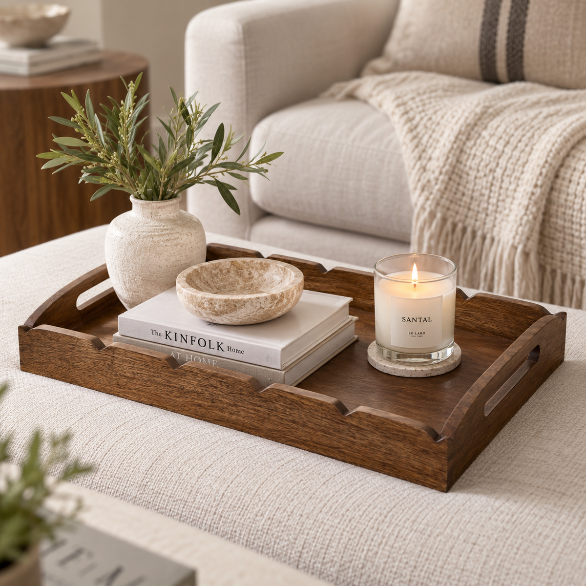 Dark wood scalloped tray styled in a neutral living room