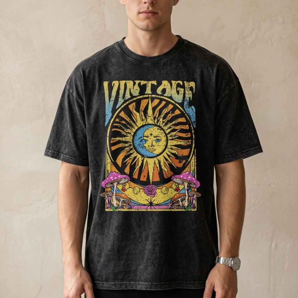 Man wearing a black vintage washed oversized t-shirt with celestial sun and moon graphic