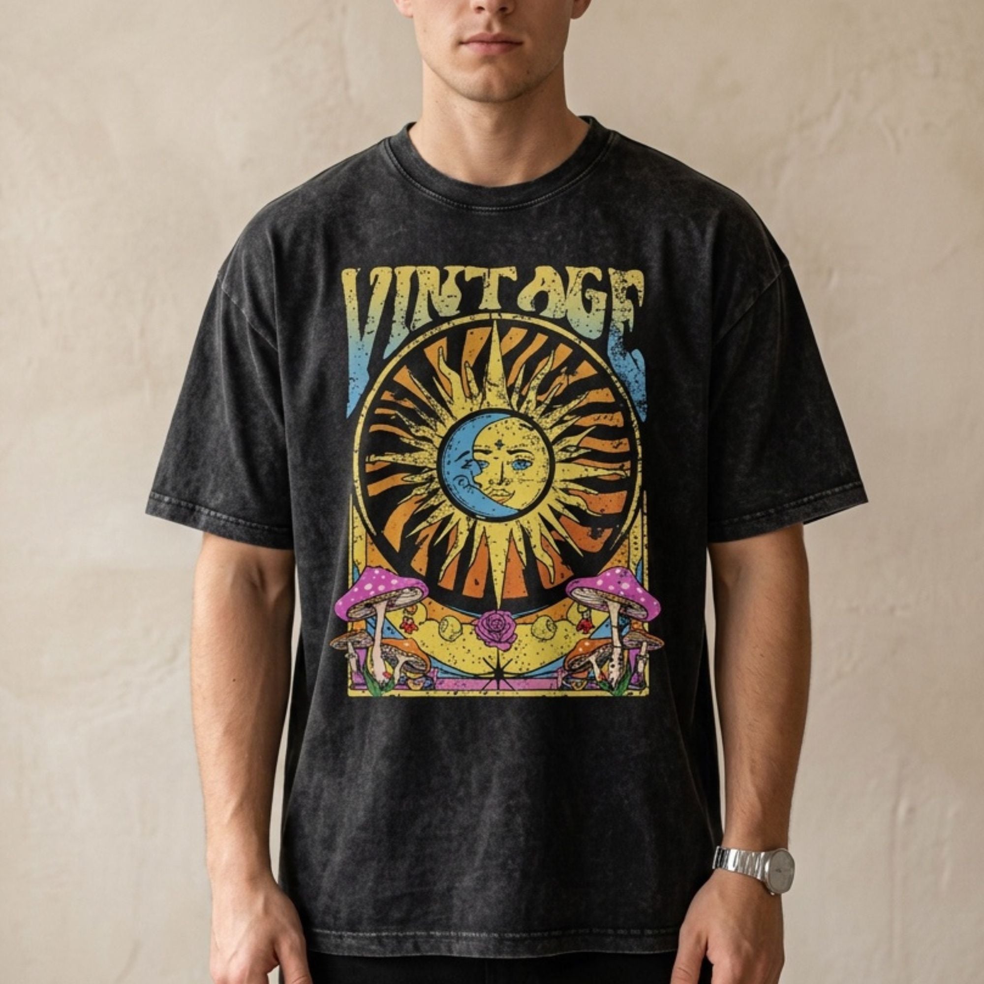 Man wearing a black vintage washed oversized t-shirt with celestial sun and moon graphic